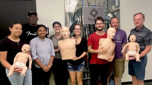 Group CPR training session with mannequins in Austin.