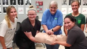 Group CPR training session in Austin with instructor and students.