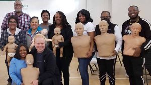 Group CPR training session with mannequins in Austin.