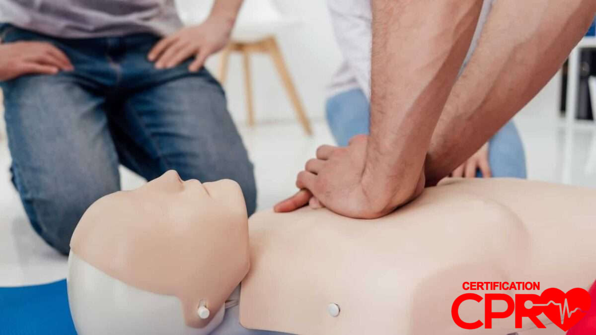 CPR training session with a man practicing on a mannequin in Austin.